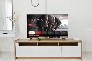 a television on a stand in a living room at Bloomfields Studio Emirates Cluster 24 Intl. City in Dubai