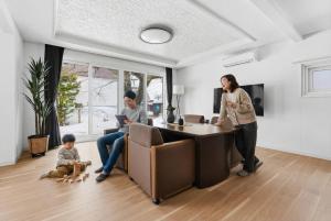 a woman and a man and a child in a living room at Nord Birch in Tōbetsu +57 photos
