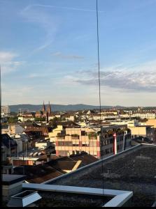 a view of a city from the roof of a building at Room with an amazing city view in Basel