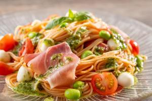 a plate of pasta with meat and vegetables at Spa Resort Hawaiians Hotel Hawaiians in Iwaki