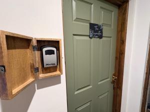 a door with a pay sign next to it at True Lovers Knot, Tarrant Keyneston in Tarrant Keynston