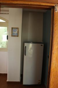 a kitchen with a refrigerator in a room at Tecoma studios Lighthouse in Dahab