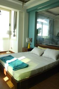a bedroom with a large bed with a large window at Tecoma studios Lighthouse in Dahab