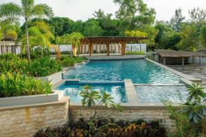 a swimming pool with a gazebo in a yard at Brio de Agoho Zambales by Cherry in Candelaria
