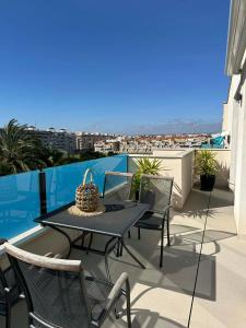 a patio with a table and chairs on a balcony at Prestige Sunny Terrace Apartment - Torrevieja in Torrevieja