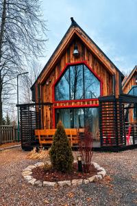 a log cabin with a bench in front of it at Czerwona Stodoła Karkonoska in Podgórzyn