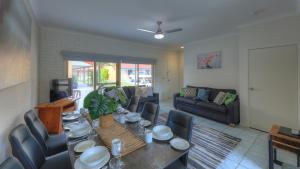 a living room with a table and a couch at Yamba Motor Inn in Yamba