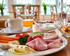 a plate of food with meat and vegetables on a table at Landhotel Kachelofa in Vaihingen an der Enz