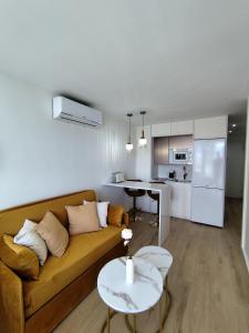 a living room with a couch and a table at Blue Piscis Studio - Piscina in Benalmádena