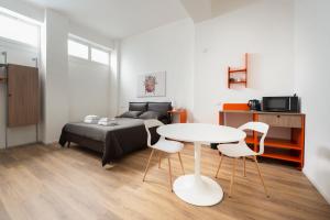 a bedroom with a bed and a table and chairs at Ospitalità Il Prato in Iesi