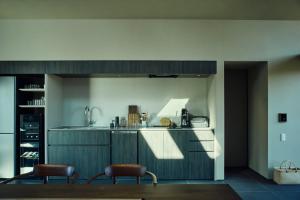 a kitchen with two chairs and a counter top at Hiire IZU OMURO in Ito