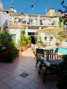 a patio with a table and chairs and an umbrella at Casa Sibarita in Rafelguaraf