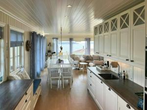 a kitchen and living room with a table and chairs at Cottage With Private Dock By Eidangerfjord in Porsgrunn