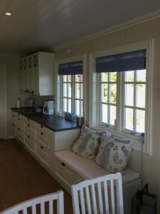 a kitchen with a bench with two windows and a counter at Cottage With Private Dock By Eidangerfjord in Porsgrunn +32 photos