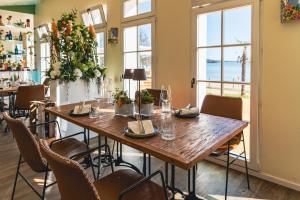 a dining room with a wooden table and chairs at Hotel Esplanade Resort & Spa - Adults Only in Bad Saarow