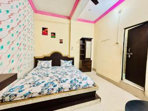 a bedroom with a bed and a wall with butterflies at Naimisharanya Residency in Naimishāranya