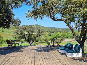 a patio with a table and chairs under a tree at Lost Paradise - Cosy Wagon in Sabóia +7 photos