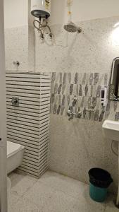 a bathroom with a shower and a sink and a toilet at Cherry Blossom in Varanasi +7 photos