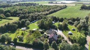 an aerial view of a house in the middle of a field at Pipowagen in Grashoek