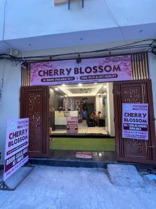 a store with signs on the front of a building at Cherry Blossom in Varanasi