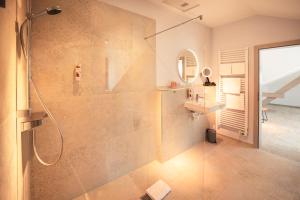 a bathroom with a shower with a glass door at Weinhotel OFFENSTEIN ERBEN in Eltville +31 photos