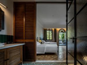 a bedroom with a bed and a bathroom at La MAISON Banshan in Chongqing