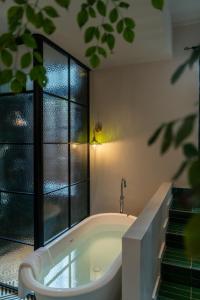 a bathroom with a bath tub next to a window at La MAISON Banshan in Chongqing +55 photos