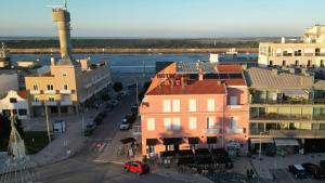 an aerial view of a city with a river and buildings at Hotel Farol in Praia da Barra