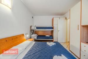 a bedroom with a bed and a bunk bed at Residence La Rotonda in Cervia +82 photos