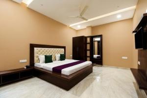 a bedroom with a large bed in a room at Hotel Savera Amritsar Near Golden Temple in Amritsar