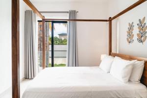 a bedroom with a bed and a large window at Mango House - 2 Bedrooms & Private Pool in La Gaulette +15 photos