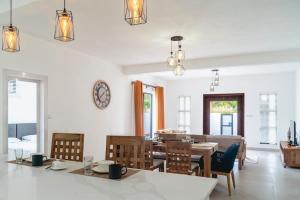 a dining room with a table and chairs at Mango House - 2 Bedrooms & Private Pool in La Gaulette