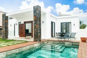 a villa with a swimming pool and a house at Mango House - 2 Bedrooms & Private Pool in La Gaulette