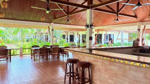 a bar with chairs and tables in a restaurant at Kamala Garden Bungalows in Kamala Beach