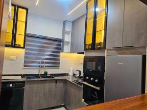 a kitchen with stainless steel appliances and a sink at Luxe Flat Light in Mama