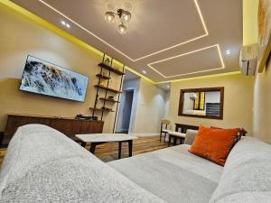 a living room with a couch and a table at Luxe Flat Light in Mama +13 photos