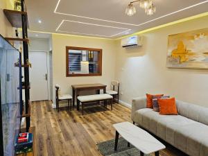a living room with a couch and a table at Luxe Flat Light in Mama