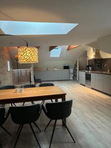 a dining room and kitchen with a table and chairs at Fiskargränden, Landskrona in Landskrona