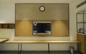 a large mirror on a wall with a clock on it at Hotel Shubham Prestige RC Puram in Lingampalli