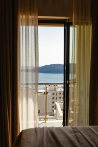 a bedroom with a window with a view of the ocean at The Dream Getaway & Spa by DeVasco in Bečići