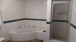 a bathroom with a sink and a shower at Trout Ways in Waterval Boven +26 photos