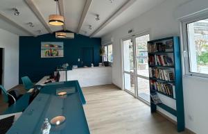 a living room with a table and a book shelf at Camping Le Platin - La Redoute in Rivedoux-Plage