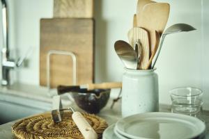 a table with a vase filled with wooden spoons at Hiire IZU FUTO in Ito