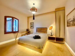 a bedroom with a bed and a lamp in it at Shangri-La Travellers' Hostel in Castel dellʼAlpi