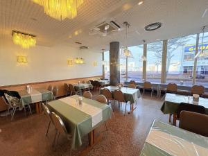 a dining room with tables and chairs and windows at APA Hotel Okhotsk Kitami in Kitami +52 photos