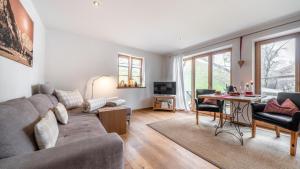 a living room with a couch and a table at Mountain Lodge in Lenggries