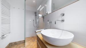 a white bathroom with a sink and a shower at Mountain Lodge in Lenggries +15 photos