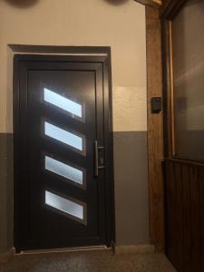 a black door with a window in a room at Relaxing in Flachslanden