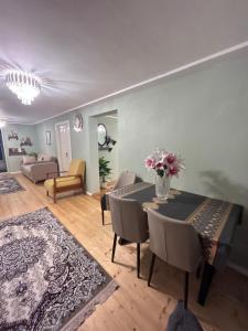 a living room with a table and chairs and a couch at Lankaran Boutique Home in Lankaran