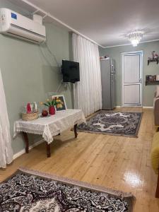 a living room with a table in front of a door at Lankaran Boutique Home in Lankaran